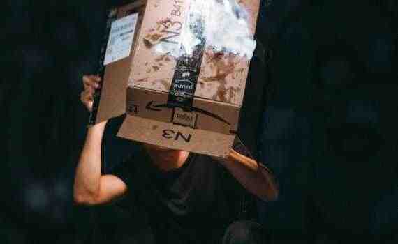 man raising cardboard box