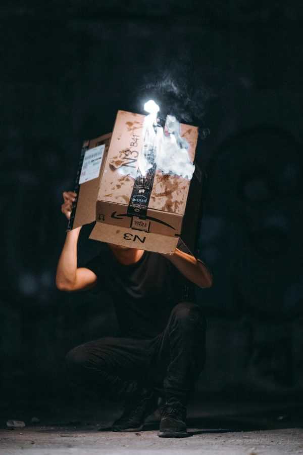 man raising cardboard box