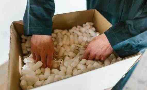 A Person Putting the Glasses in a Box Full of Polystyrene Foam