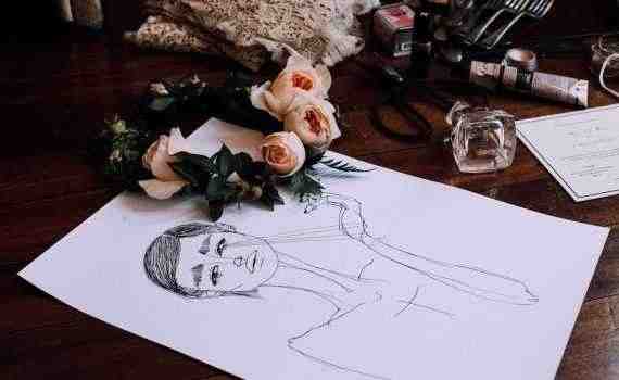 Creative drawing placed on vanity table with scattered cosmetics