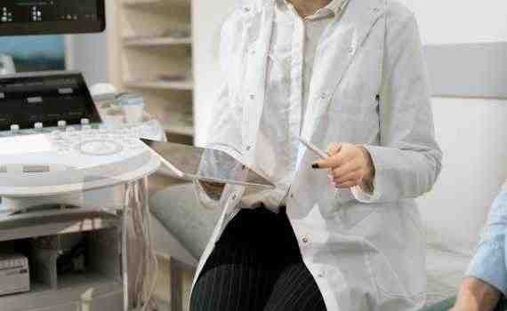 Photo Of Gynecologist Sitting Near Medical Equipment