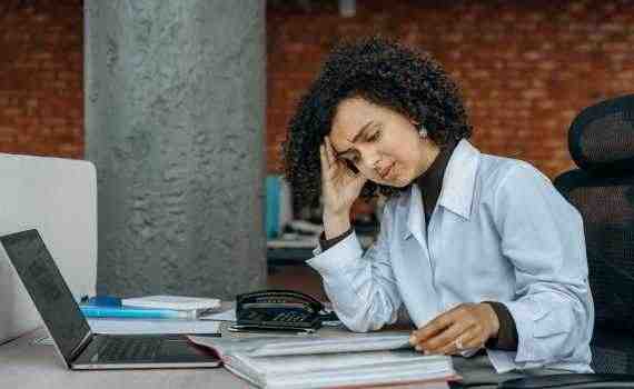 An Exhausted Woman Reading Documents