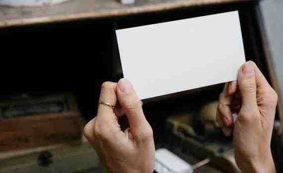 Crop unrecognizable woman showing blank card