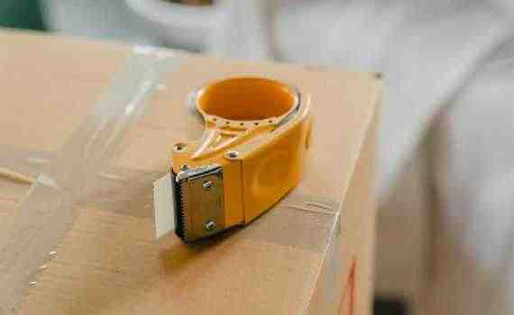 Packing tape gun on carton box