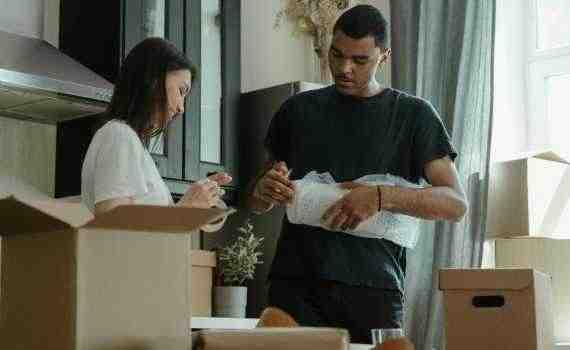 Man in Blue Crew Neck T-shirt Holding Woman in White Long Sleeve Shirt