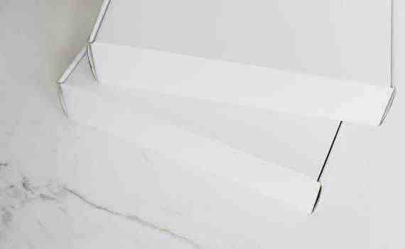 Set of white carton packages on marble surface