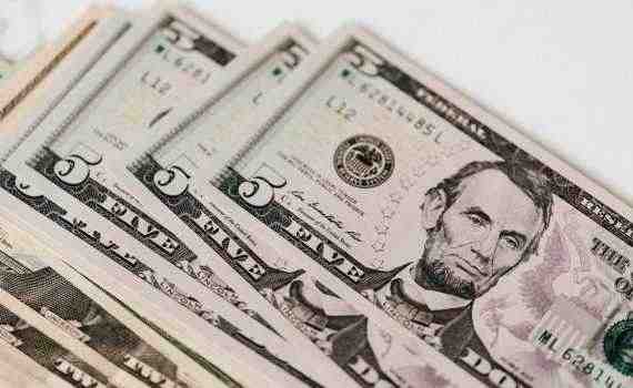 Heap of money on white surface