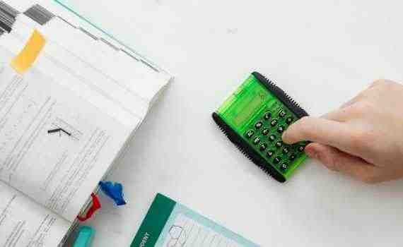 Person Using A Green and Black Calculator